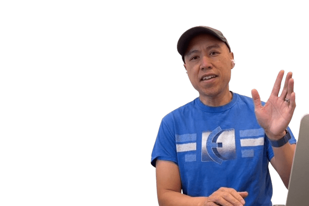 A man in a blue t-shirt and cap is smiling and waving with his right hand while sitting at a table with a laptop, perhaps discussing The Perception of Pain. The background is transparent.