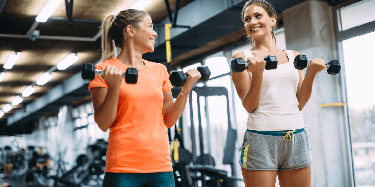 Two women lifting weights sermorelin for women