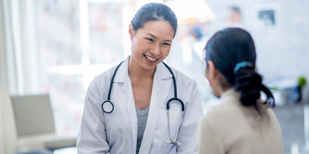 A female doctor talking with a patient