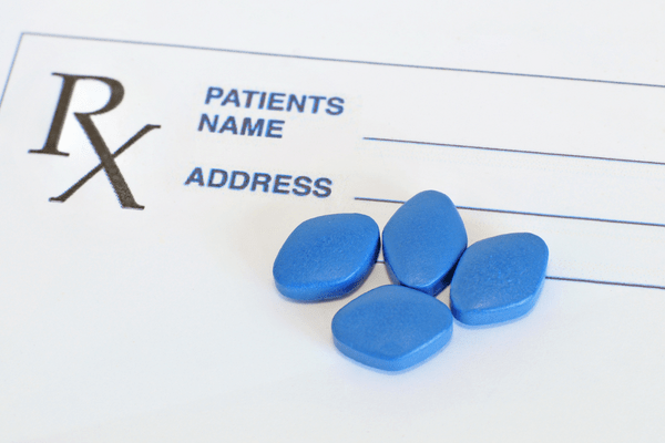 Blue pills on a prescription pad.