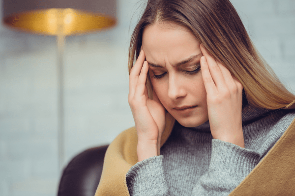 A woman with a headache.