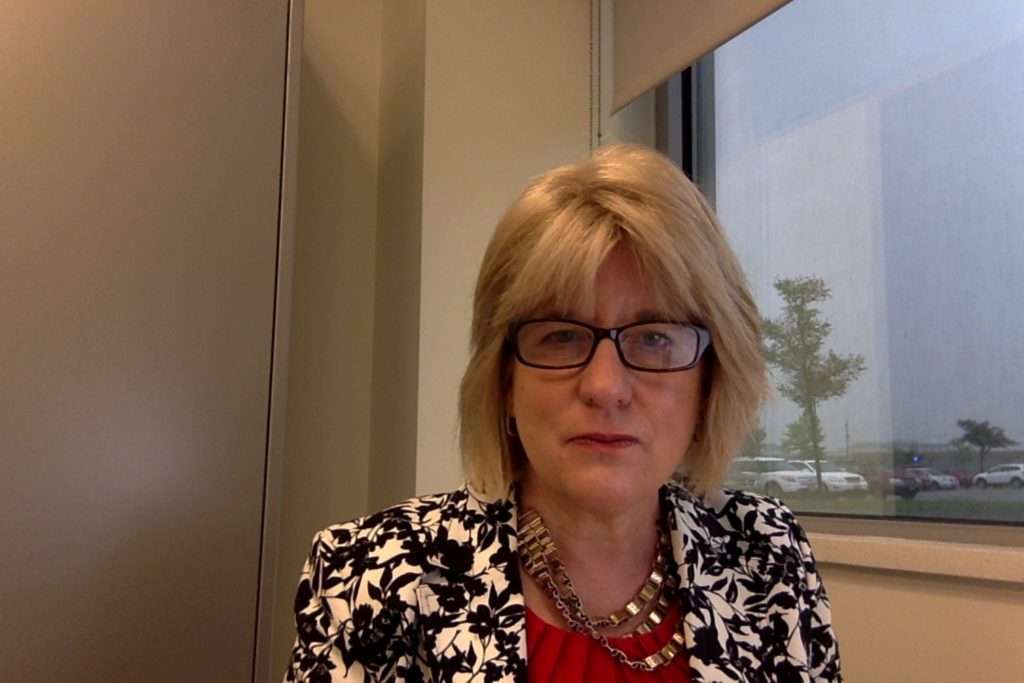 A woman in glasses with shoulder length blonde hair
