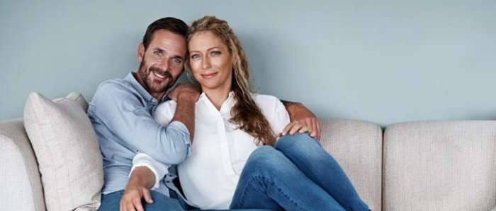 A couple sitting on a couch