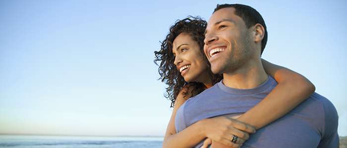 A woman hugging a man from behind