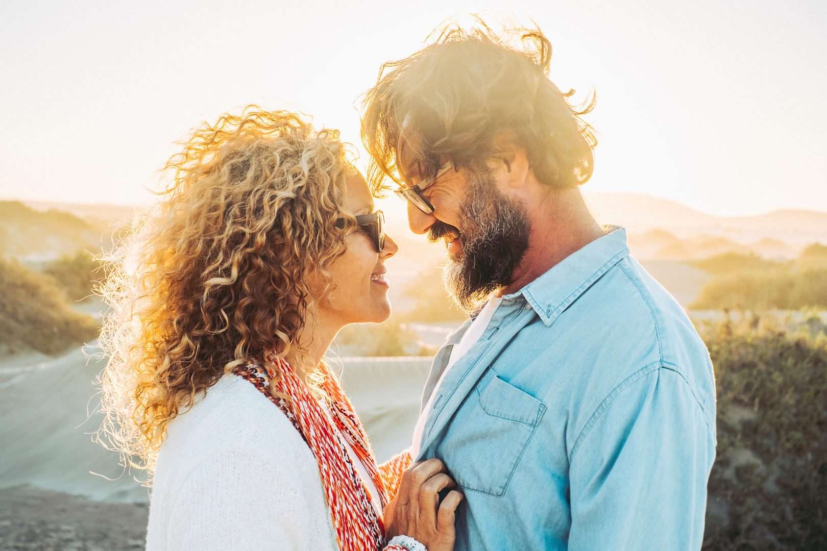 An older couple looking at each other, smiling