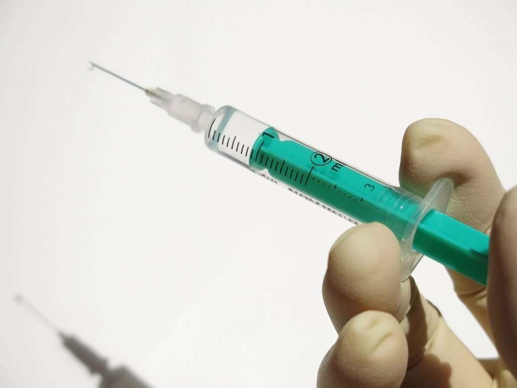 A Doctor Readies a Syringe for a B12 Injection